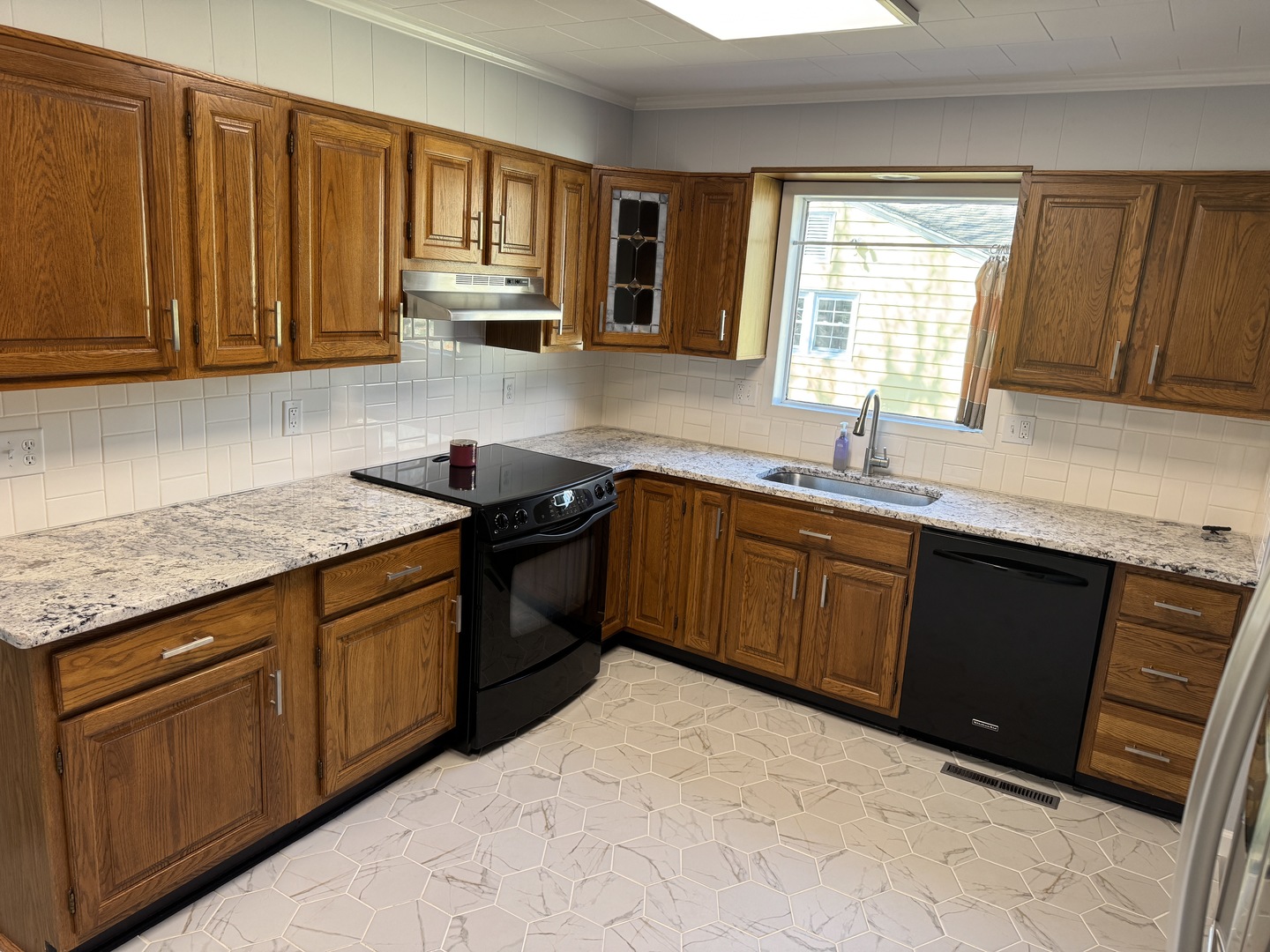 403 Mitchell Street Benton, IL 62812 - Photo 11 of 44 a kitchen with stainless steel appliances granite countertop wooden cabinets a sink and dishwasher