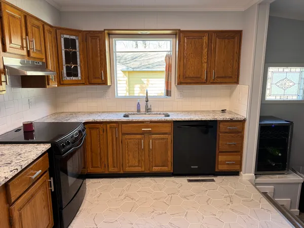 a kitchen with a sink stove top oven and cabinets