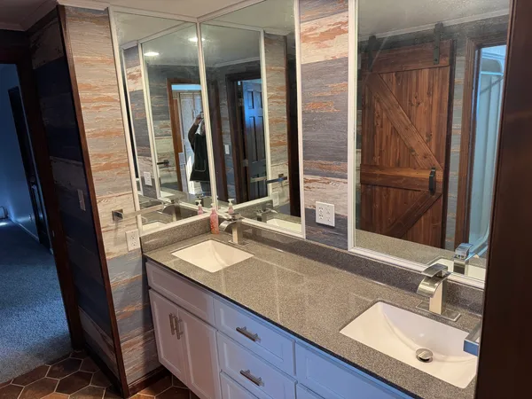 a bathroom with a sink double vanity and a mirror