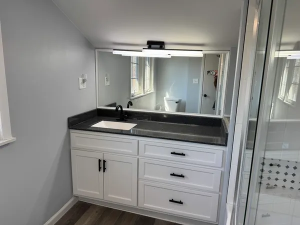 a bathroom with a sink and a mirror