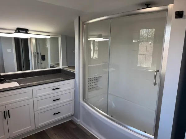 a bathroom with a bathtub and a shower