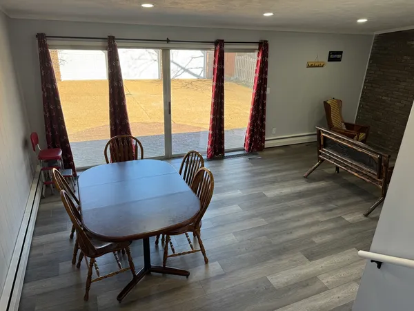 a dining room with furniture and wooden floor