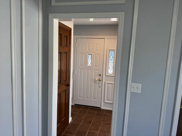 a view of a hallway with a wooden door