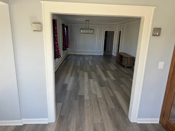 a view of hallway with wooden floor