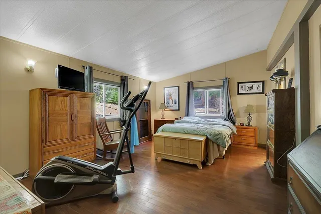 a bedroom with a bed and gym equipment