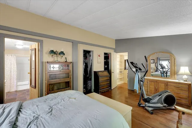 a bedroom with a bed and gym equipment