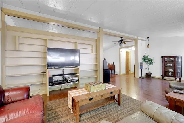 a living room with furniture and a wooden floor