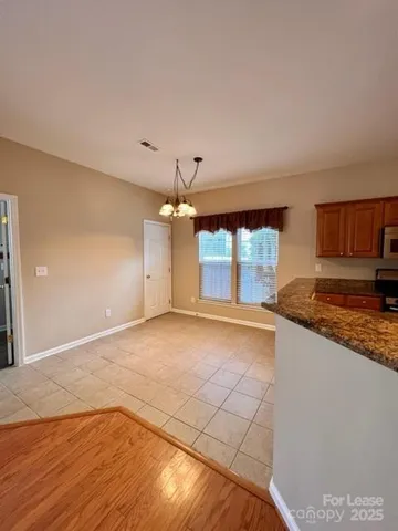 a view of a kitchen with a sink and a window