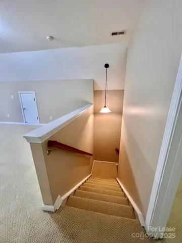 a view of an empty room with stairs