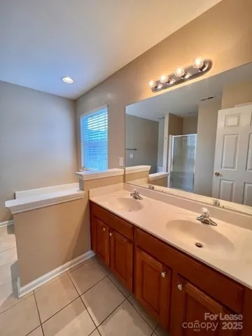 a bathroom with a sink double vanity and a mirror