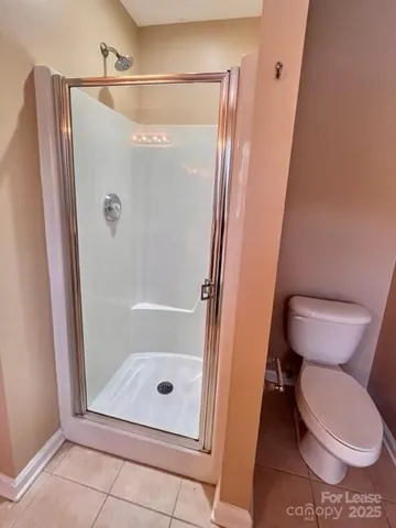 a bathroom with a toilet and a shower
