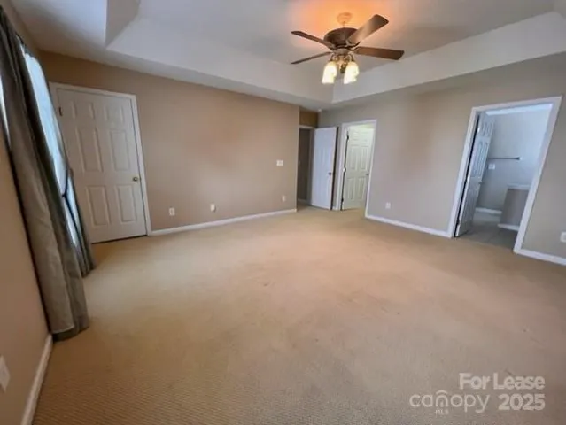 a view of a livingroom with a ceiling fan and window