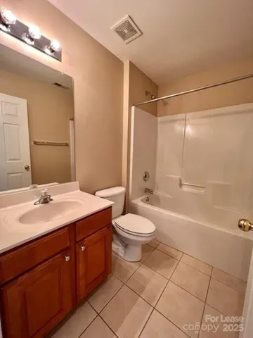a bathroom with a double vanity sink toilet mirror and shower