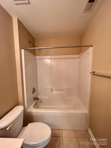 a bathroom with a toilet and a bath tub