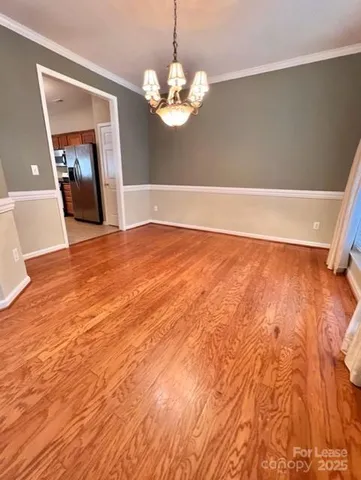 a view of a room with wooden floor