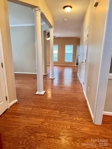 a view of a hallway with wooden floor