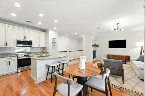 a view of kitchen with cabinets table and chairs