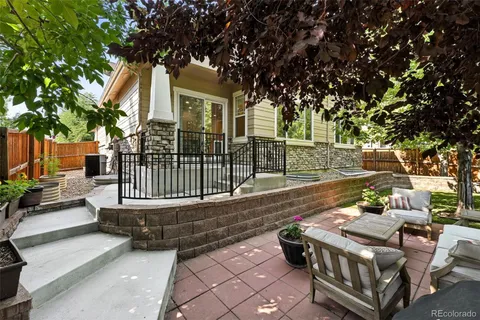 a view of a patio with couches table and chairs and potted plants