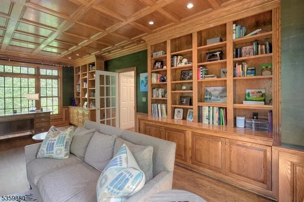 a living room with furniture and a book shelf