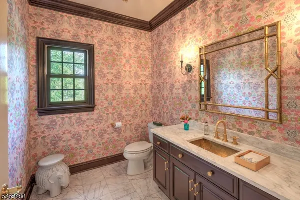 a bathroom with a granite countertop sink a toilet and a mirror