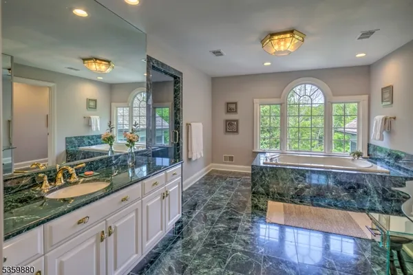 a large bathroom with a large window and double vanity