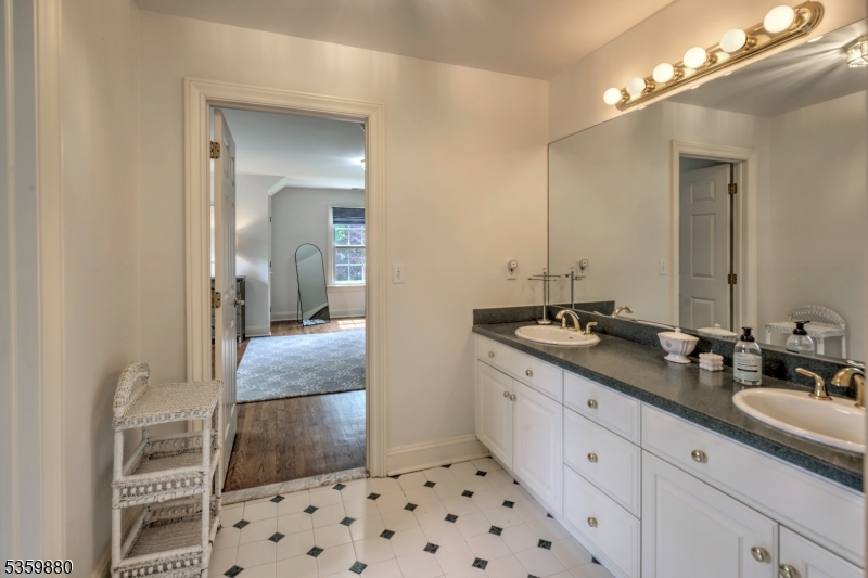 51 Post Kennel Road Bernardsville, NJ 07924 - Photo 28 of 43 a bathroom with a double vanity sink and a mirror