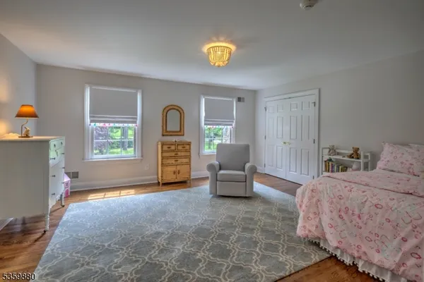 a bedroom with furniture and a window