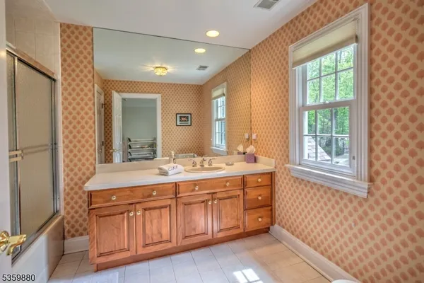 a bathroom with a sink a vanity and a mirror