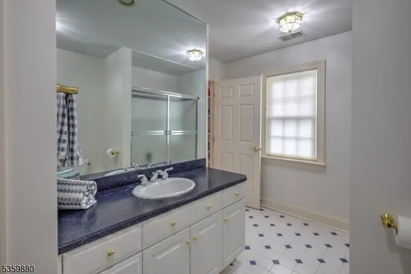 a bathroom with a sink double vanity and a mirror