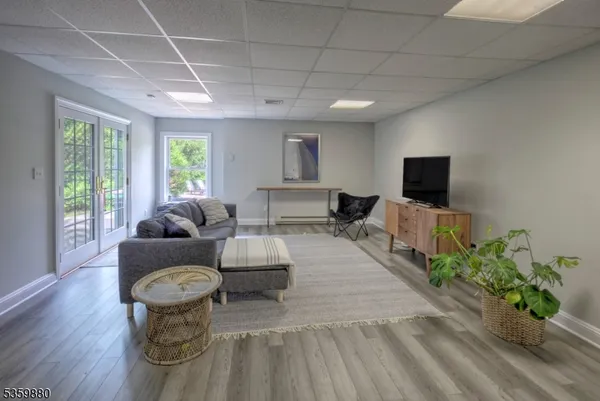 a living room with furniture a flat screen tv and a potted plant