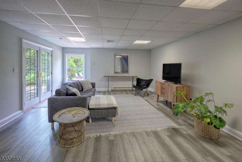 51 Post Kennel Road Bernardsville, NJ 07924 - Photo 34 of 43 a living room with furniture a flat screen tv and a potted plant