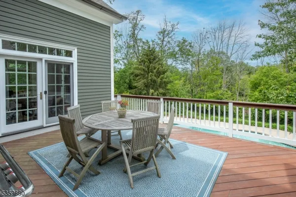 a view of a chairs and a table in the balcony