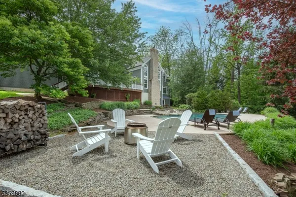 a view of a chairs and table in backyard