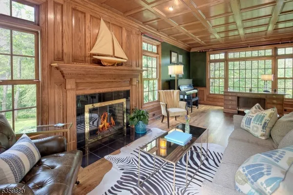 a living room with furniture a fireplace and a large window