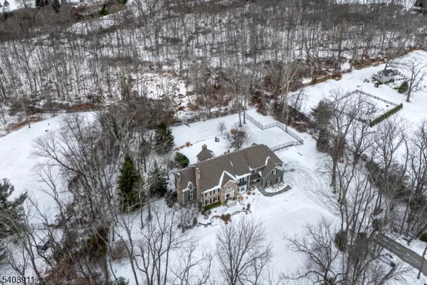a view of a house with a snow on the forest