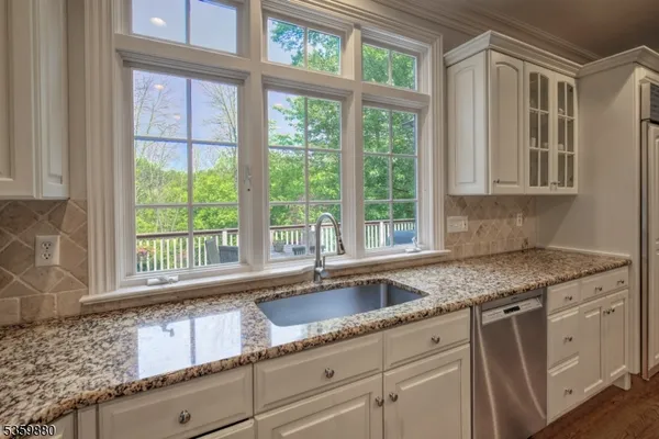 a kitchen with granite countertop a sink and a window