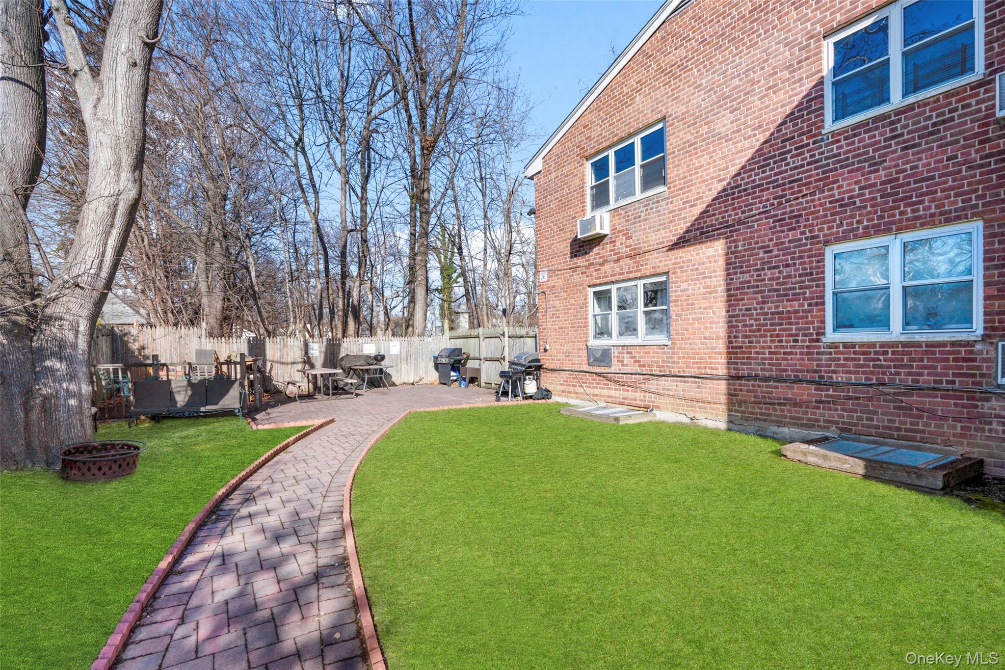 179 Drake Avenue, Unit 2J New Rochelle, NY 10805 - Photo 13 of 16 Fenced backyard with a patio area
