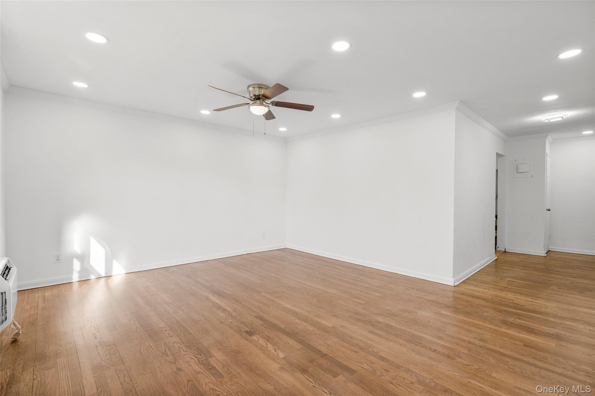 179 Drake Avenue, Unit 2J New Rochelle, NY 10805 - Photo 3 of 16 Living room featuring crown molding, recessed lighting, light wood flooring, and a ceiling fan