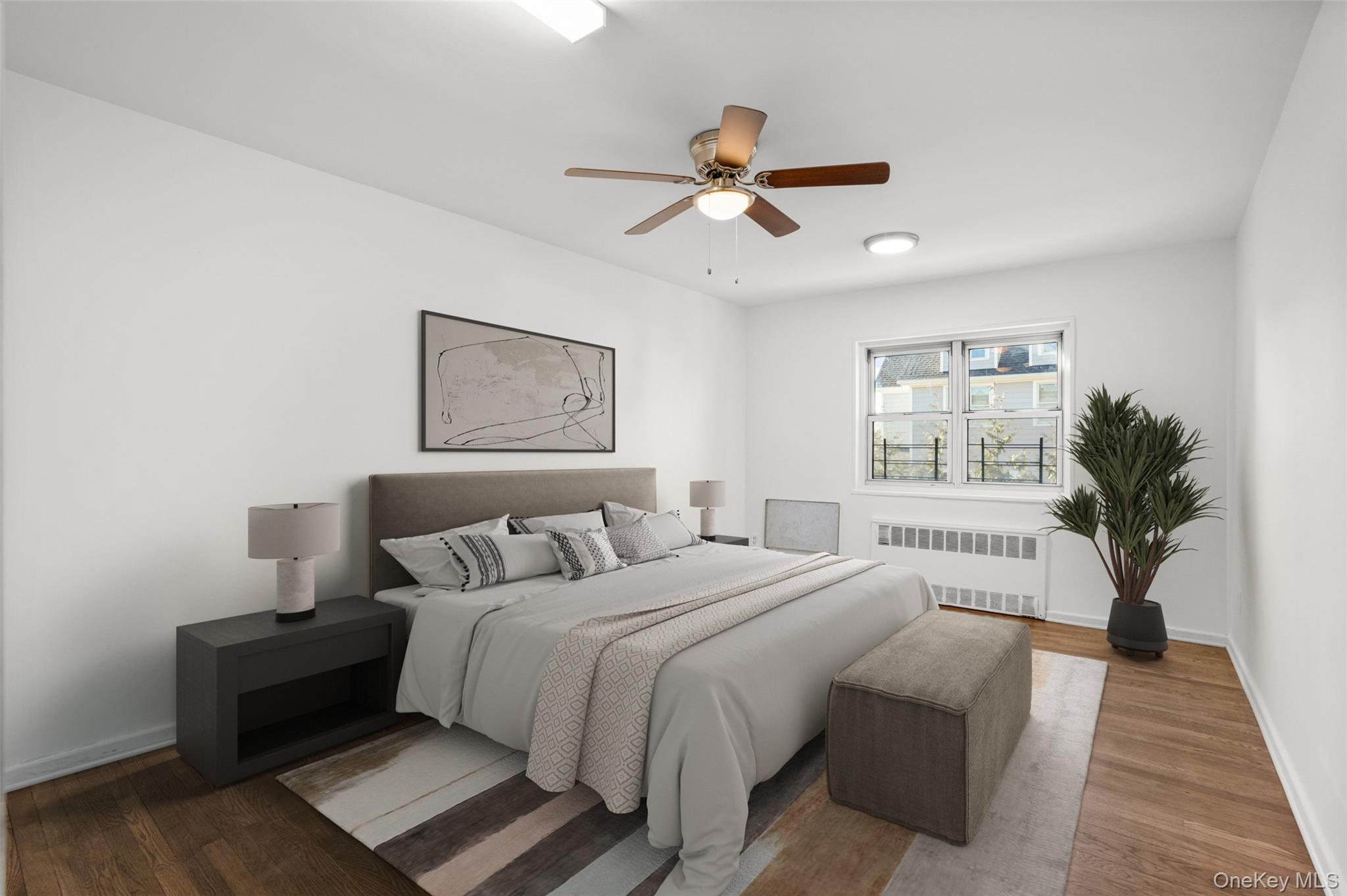 179 Drake Avenue, Unit 2J New Rochelle, NY 10805 - Photo 9 of 16 Bedroom with radiator heating unit, wood finished floors, and a ceiling fan