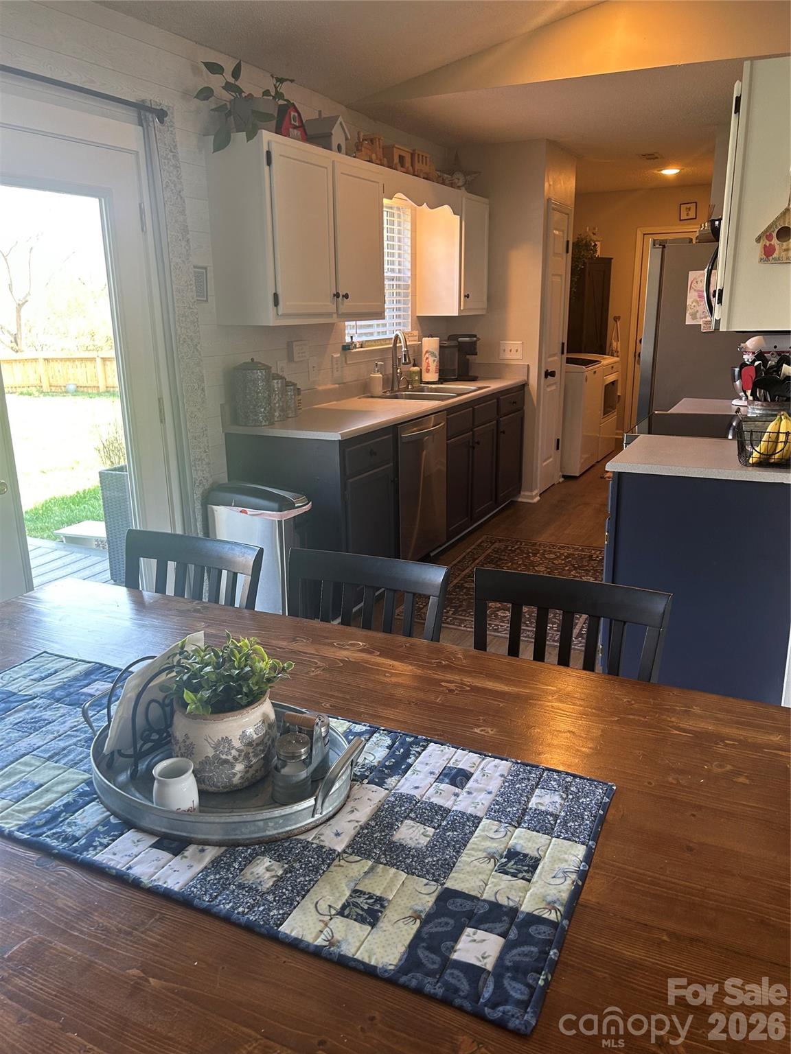 110 Shenandoah Loop Troutman, NC 28166 - Photo 11 of 24 a kitchen with stainless steel appliances granite countertop a sink and a stove
