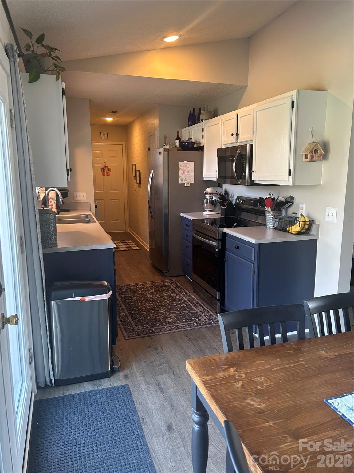 110 Shenandoah Loop Troutman, NC 28166 - Photo 12 of 24 a kitchen with stainless steel appliances granite countertop a sink stove and refrigerator