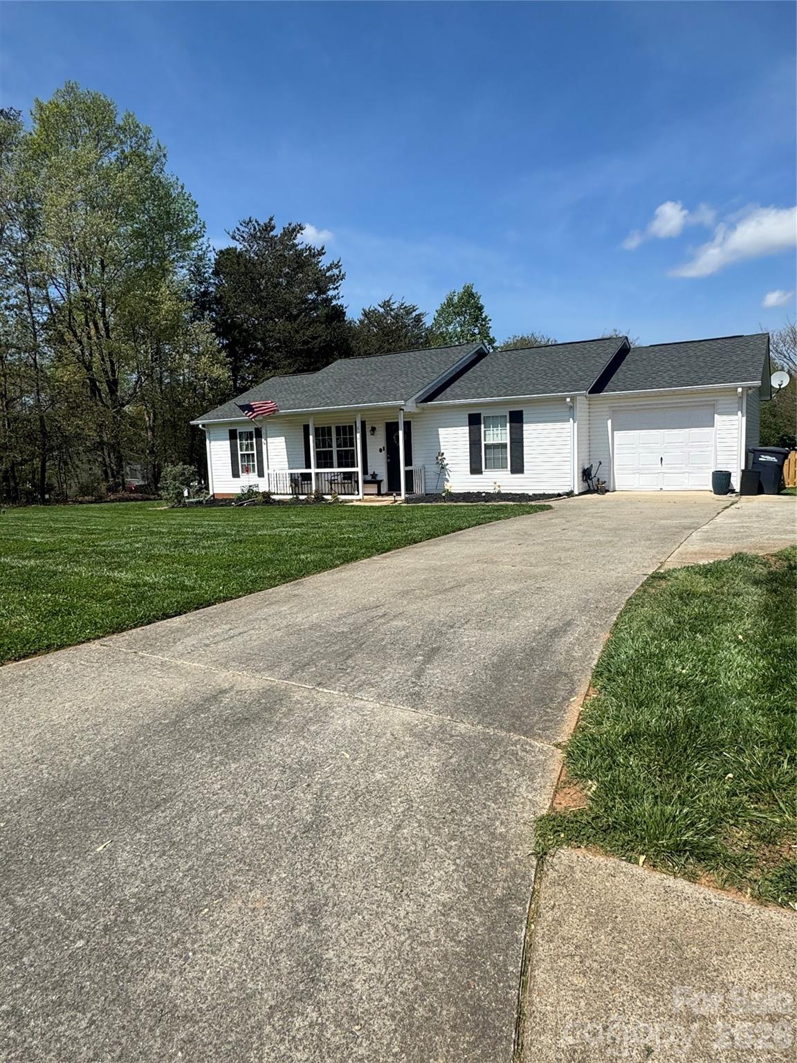 110 Shenandoah Loop Troutman, NC 28166 - Photo 2 of 24 a front view of a house with a yard and garage