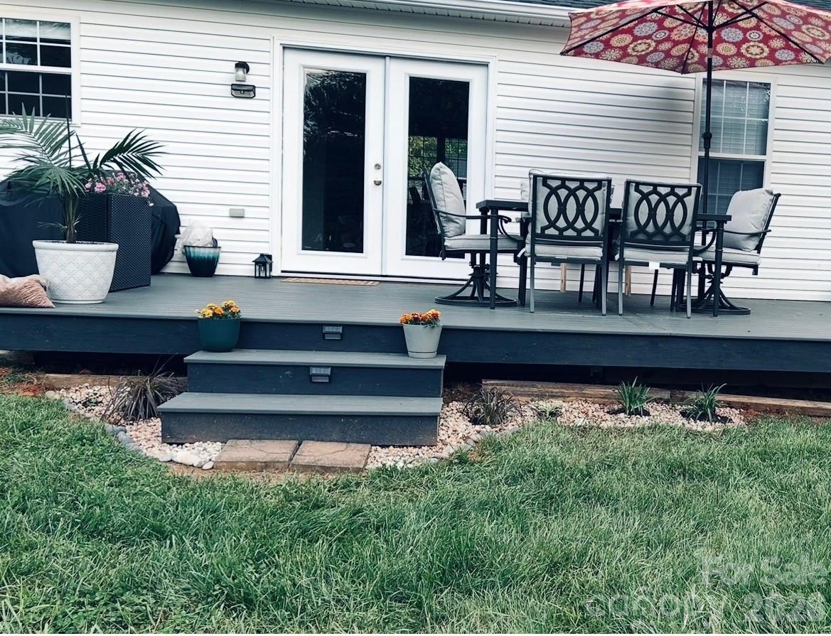 110 Shenandoah Loop Troutman, NC 28166 - Photo 3 of 24 a view of a chair and table in the back yard of the house