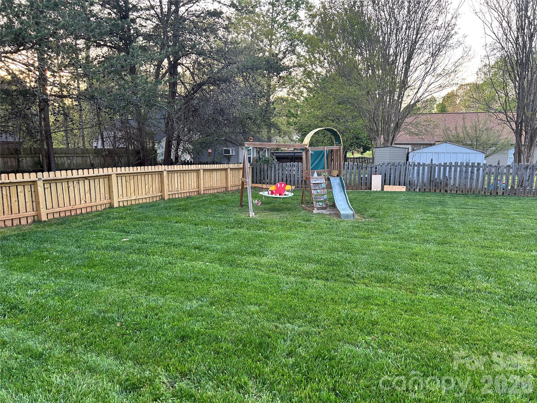 110 Shenandoah Loop Troutman, NC 28166 - Photo 4 of 24 a view of a garden with trees and playing ground