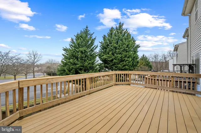 a view of wooden deck and a yard