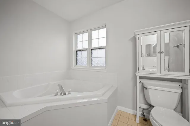 a bathroom with a sink toilet and a mirror