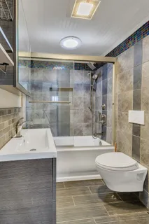 a bathroom with a sink toilet and shower