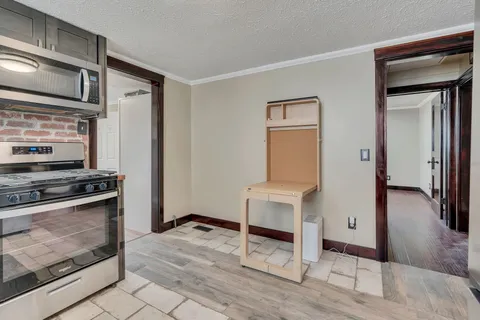 a kitchen with stainless steel appliances granite countertop a refrigerator and a stove top oven