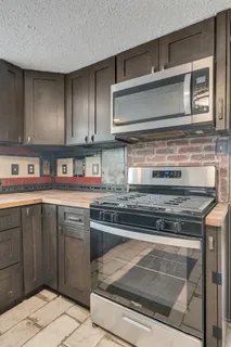 a kitchen with stainless steel appliances granite countertop a stove and a sink