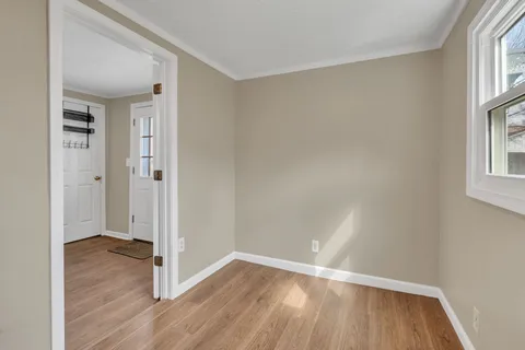 wooden floor in an empty room with a window